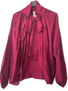 A long-sleeve blouse in deep burgundy with a high collar and a large front bow tie,