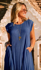 close up of lady in navy blue pleated dress