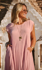 pink pleated dress with cap sleeves close up