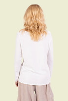 Person wearing a white long-sleeve top