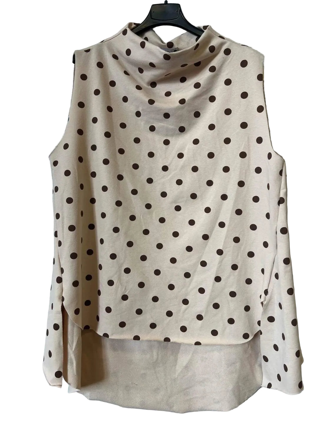 A sleeveless beige cowl-neck blouse with a brown polka dot pattern