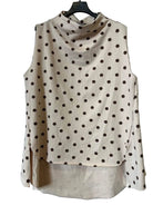 A sleeveless beige cowl-neck blouse with a brown polka dot pattern