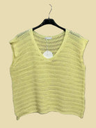 Yellow knitted top on a hanger