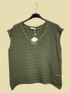 Green knitted top on a hanger