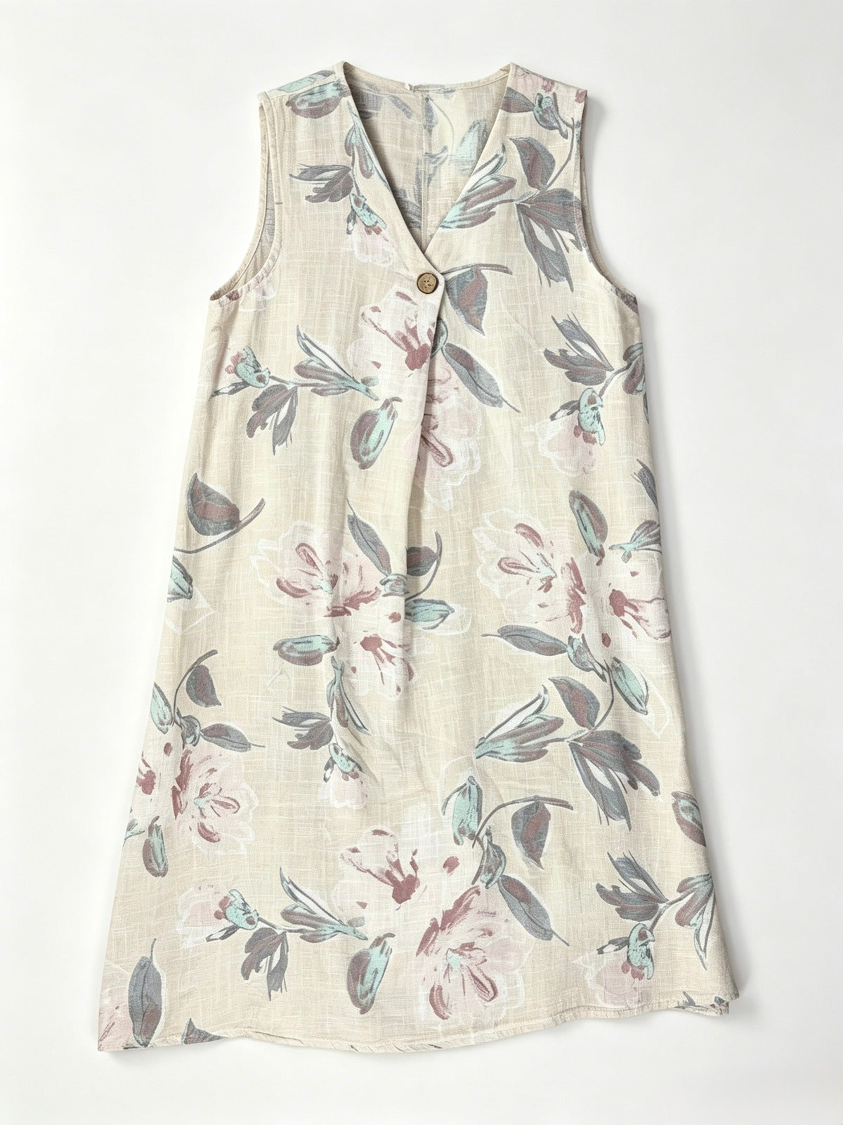A sleeveless V-neck dress with a button-up front, featuring an ecru cotton fabric 