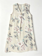 A sleeveless V-neck dress with a button-up front, featuring an ecru cotton fabric 