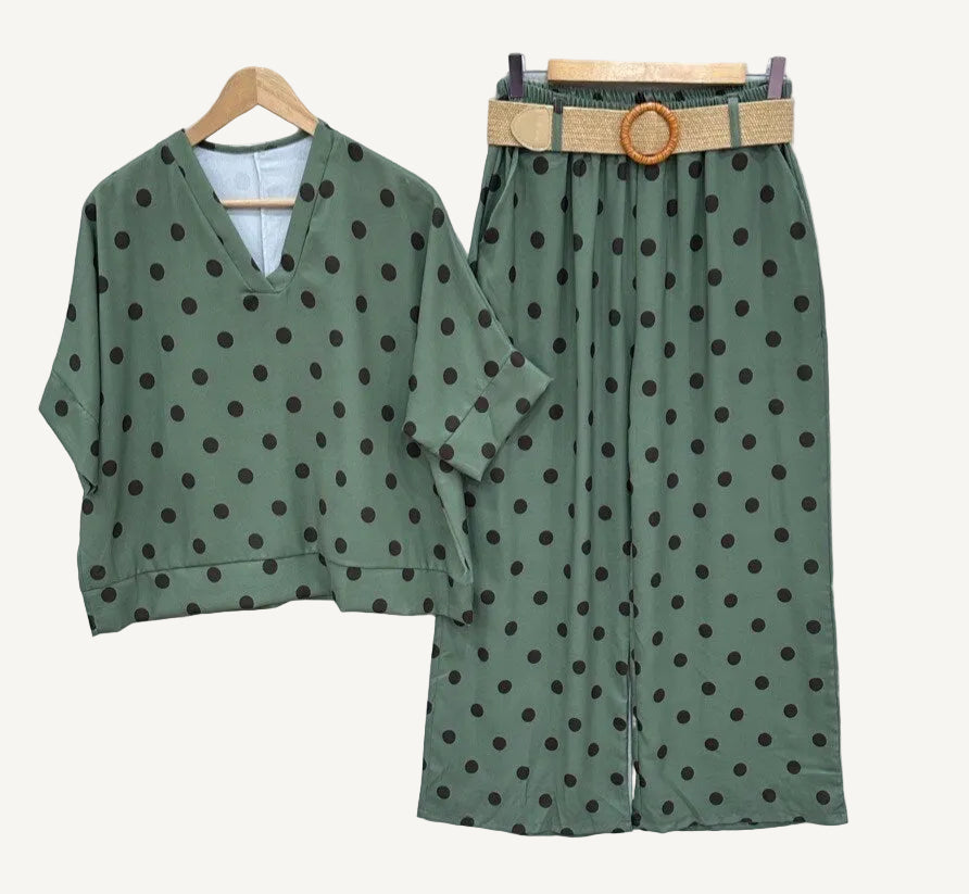 Green polka dot outfit with a belt on a white background