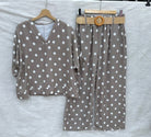 Taupe polka dot outfit with a belt on a white background