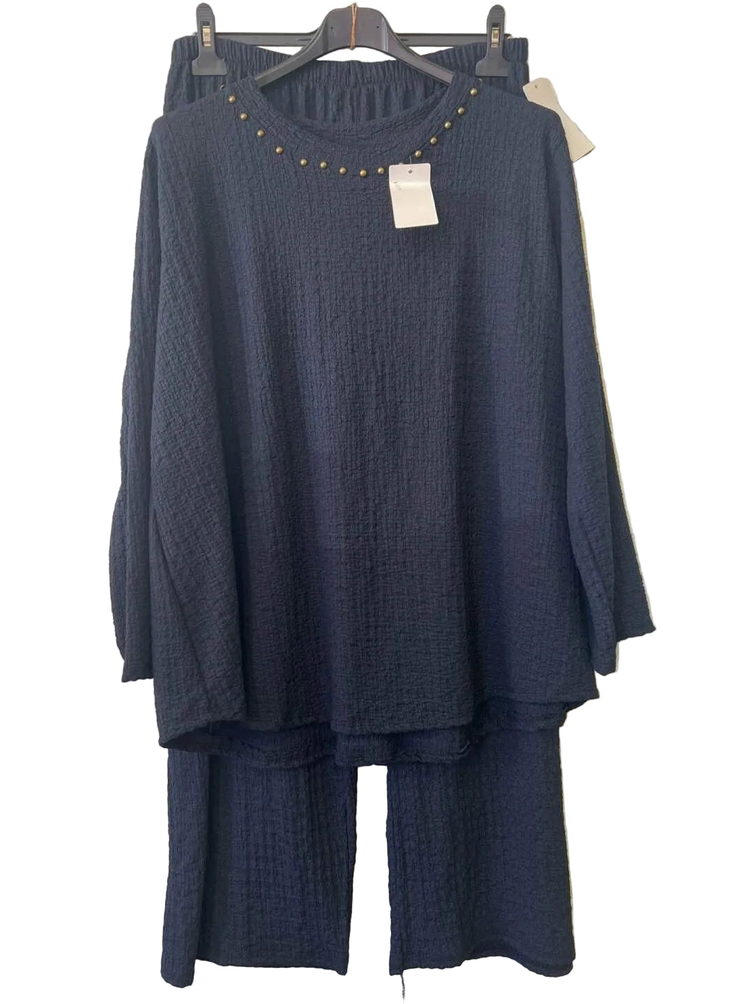 A dark navy blue two-piece lounge set consisting of a textured long-sleeve top with gold stud detailing around the neckline and matching textured pants, 