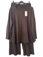 A dark brown two-piece matching set featuring a textured long-sleeve tunic top with gold stud detailing around the neckline and matching textured wide-leg pants