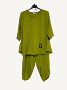 Olive two piece top and trouser set on a hanger 
