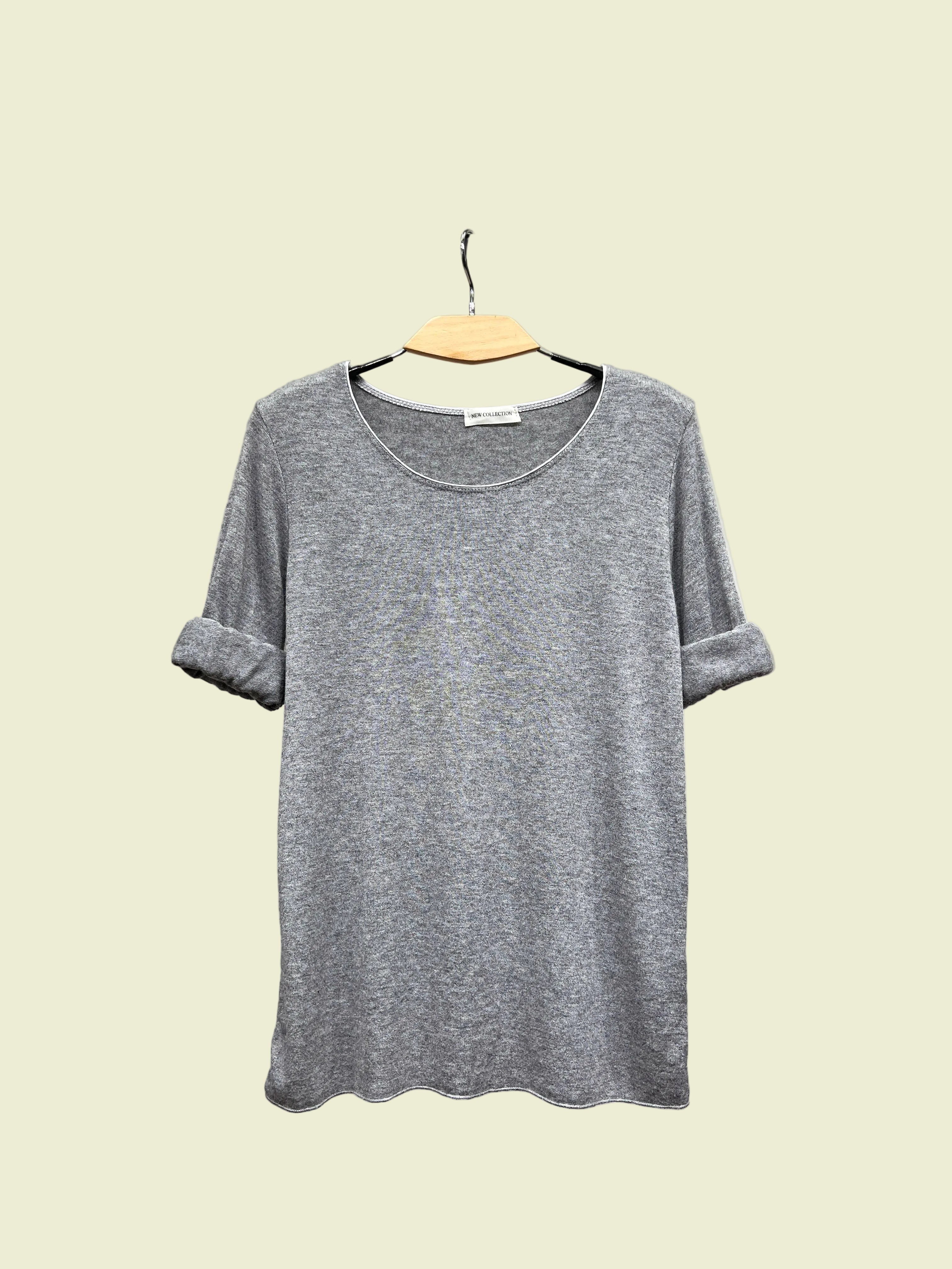 Light Grey top on a hanger against a neutral background