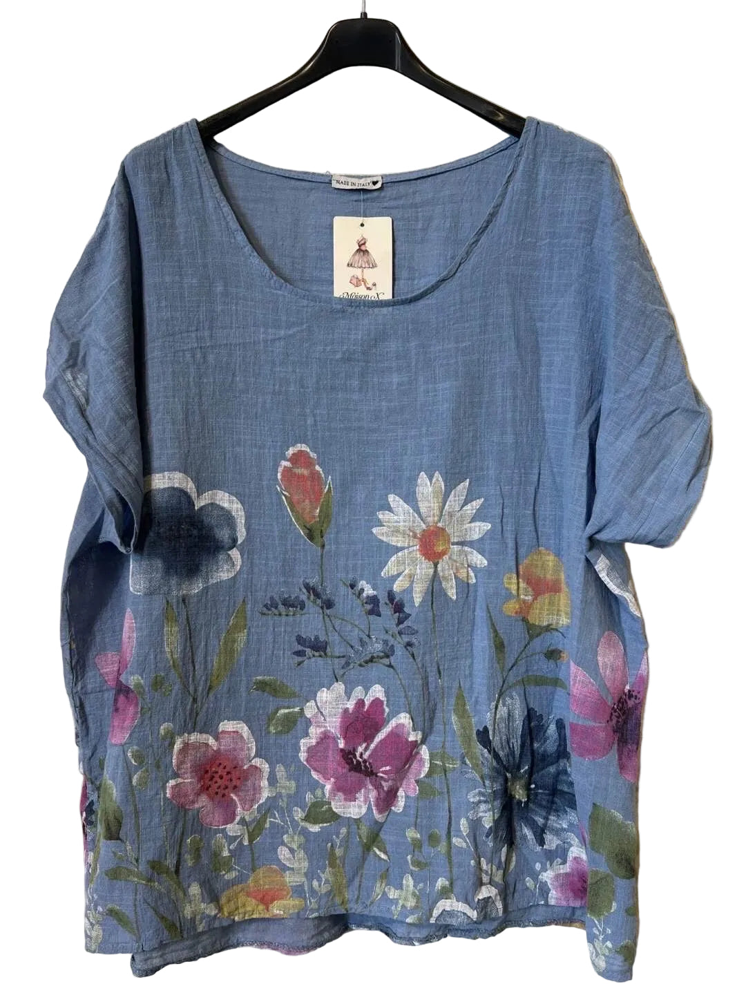 A women's short-sleeve top in blue jeans featuring a colorful floral print with pink, white, and yellow flowers.