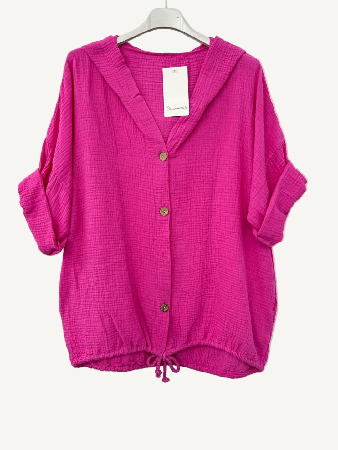 Pink cotton gauze jacket on a hanger with a white background