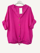 Pink cotton gauze jacket on a hanger with a white background
