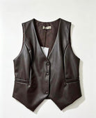 A dark brown faux-leather vest with a V-neck, button-front closure, and side pockets, laid flat against a light off-white background.