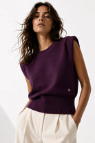 Purple sleeveless knit with padded shoulders