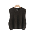 A dark brown fuzzy knit sweater vest hanging on a wooden hanger against a light gray background,