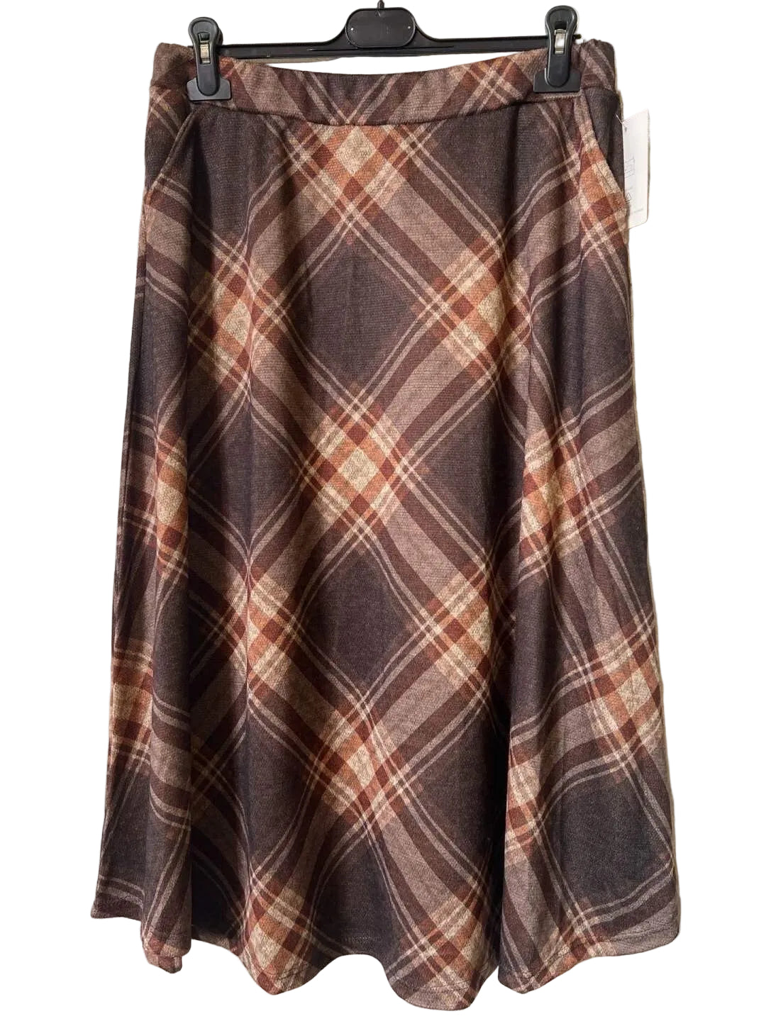 A brown plaid skirt with a warm rust-orange and beige pattern,