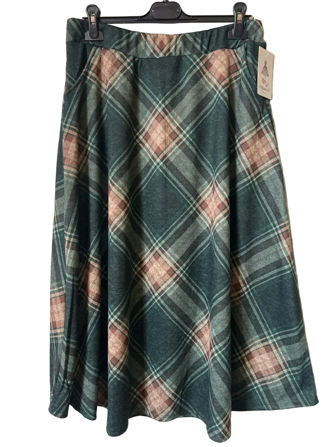 A plaid A-line skirt in dark green, dusty pink, and beige,