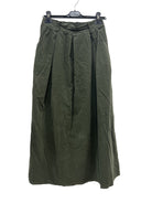Green skirt on a hanger against a white background