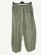 Green pants on a hanger against a white background