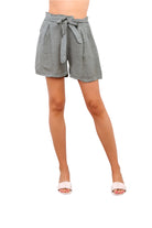 Khaki shorts with a tie waist worn by a person on a white background