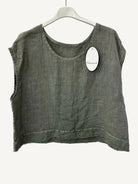 Green sleeveless top on a hanger with a visible brand tag against a white background