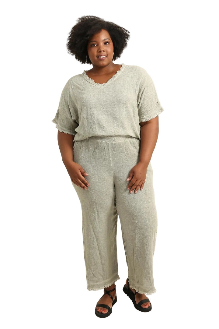 Woman wearing a khaki
 outfit on a beige background