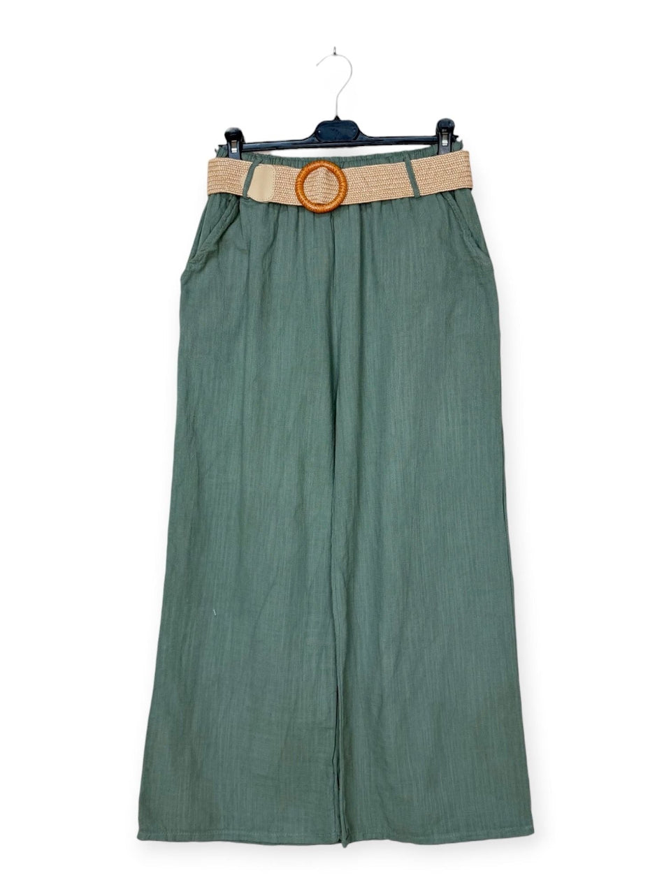 Khaki trousers with a beige belt on a hanger against a white background