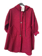 A textured, deep red hooded cardigan with drawstrings and front pockets, 