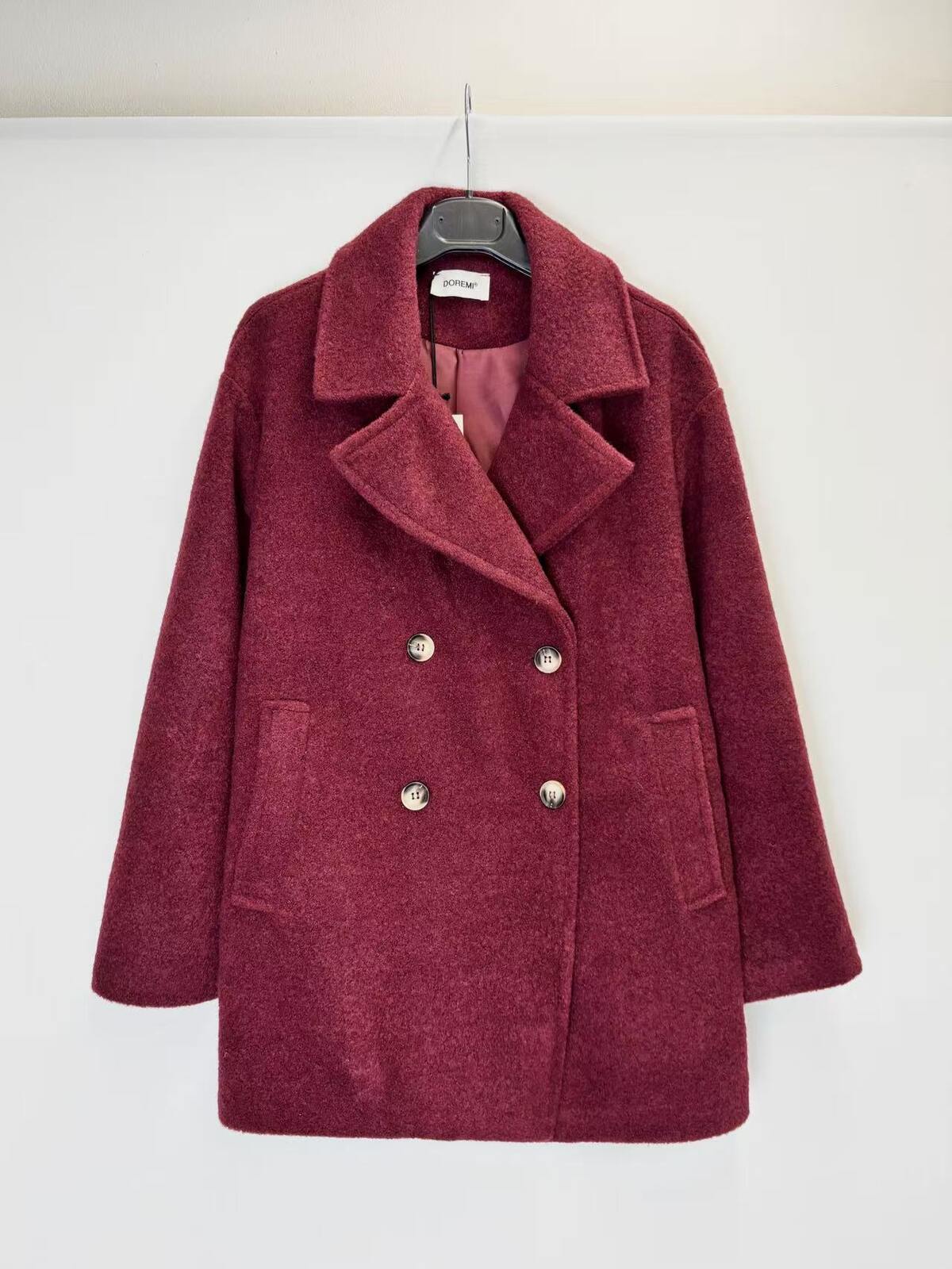 A double-breasted wool-blend coat in a deep burgundy  