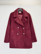 A double-breasted wool-blend coat in a deep burgundy  