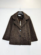 A brown textured bouclé coat with a single button closure, hanging on a black hanger against a plain white background.