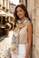 Woman wearing a patterned scarf in an outdoor setting