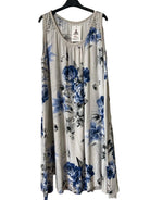 A sleeveless beige tank dress with a blue and gray floral print