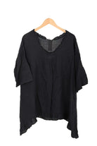 Navy Blue blouse on a wooden hanger against a white background