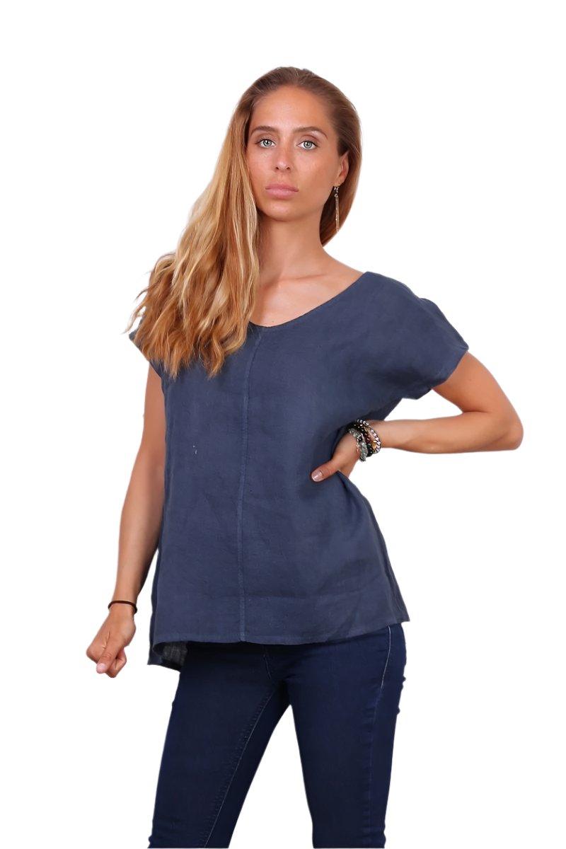 A person wearing a navy blue v-neck cap sleeve top with a loose fit.