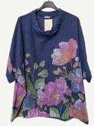 Navy blue top with colorful floral pattern on a white background