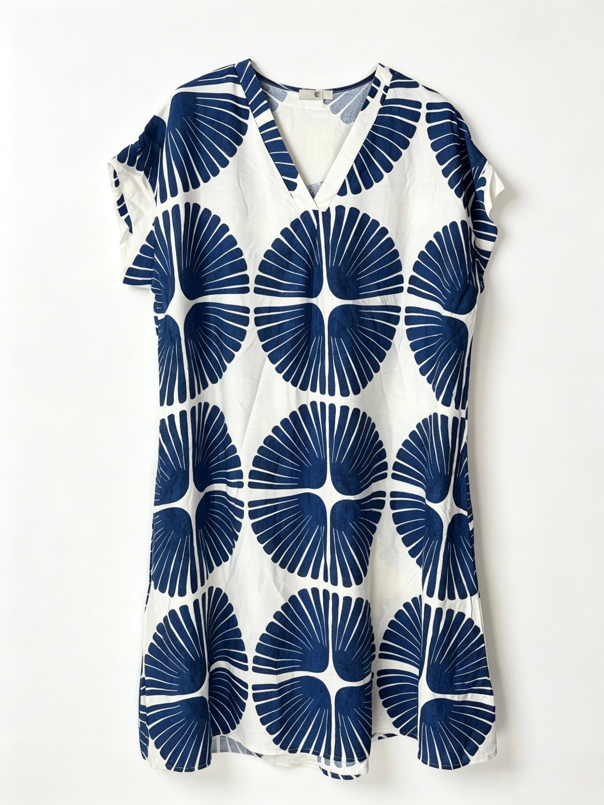 A short-sleeve V-neck dress featuring a bold navy blue and white geometric fan pattern, displayed flat against a clean white background.