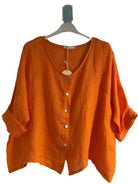 A orange one size pure linen button fronted collarless shirt with three quarter sleeves.