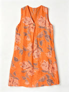 An orange sleeveless V-neck dress with a floral print 