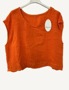 Orange sleeveless top on a hanger