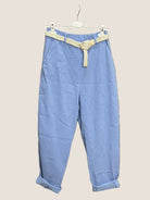 Light blue pants with a beige belt.
