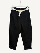 Black pants with a beige belt 