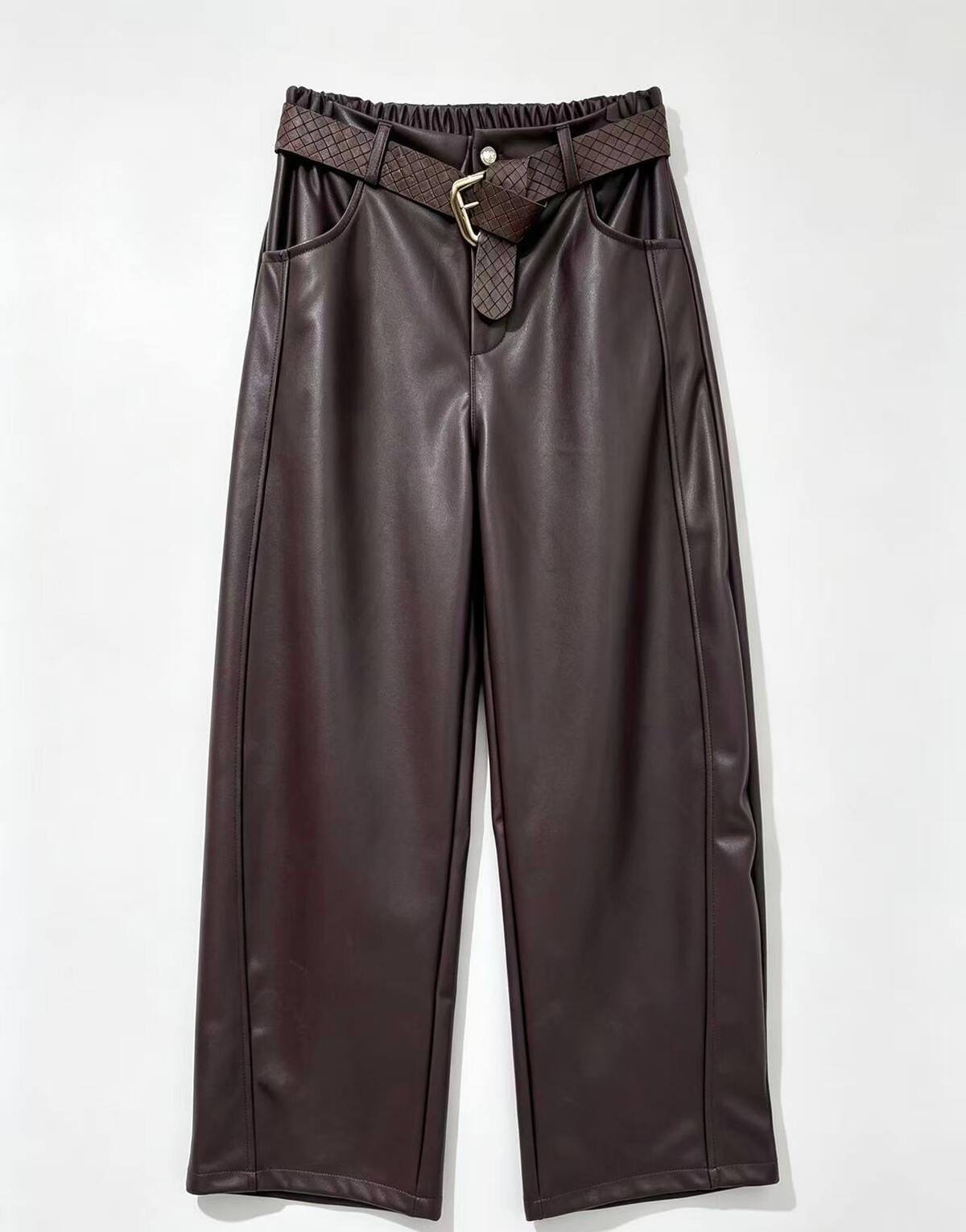 Burgundy faux leather wide-leg pants with a matching woven belt featuring a gold buckle, displayed flat against a light gray background.