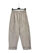 Cream coloured roll up hem barrel shaped trousers