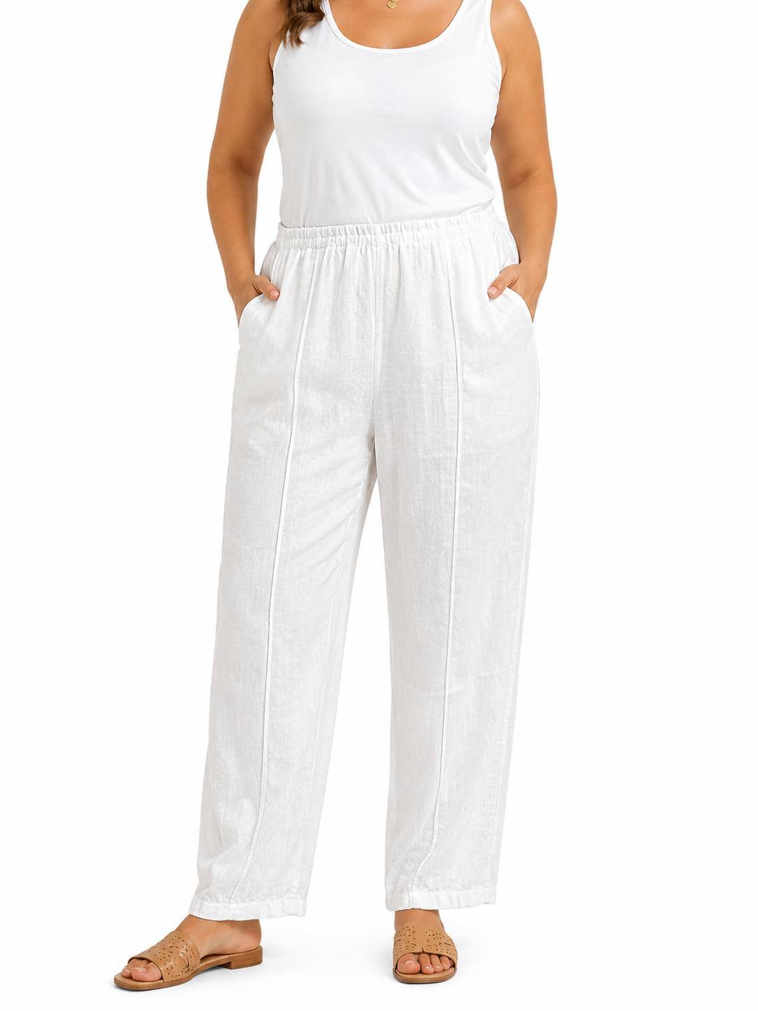 A model wearing white wide-leg linen pants with a matching white tank top and brown sandals, shown from the waist down on a white background.