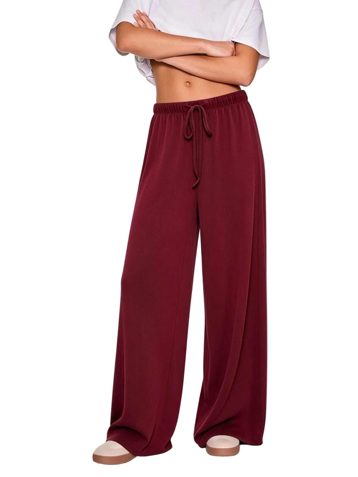 A model wearing wide-leg burgundy drawstring pants.
