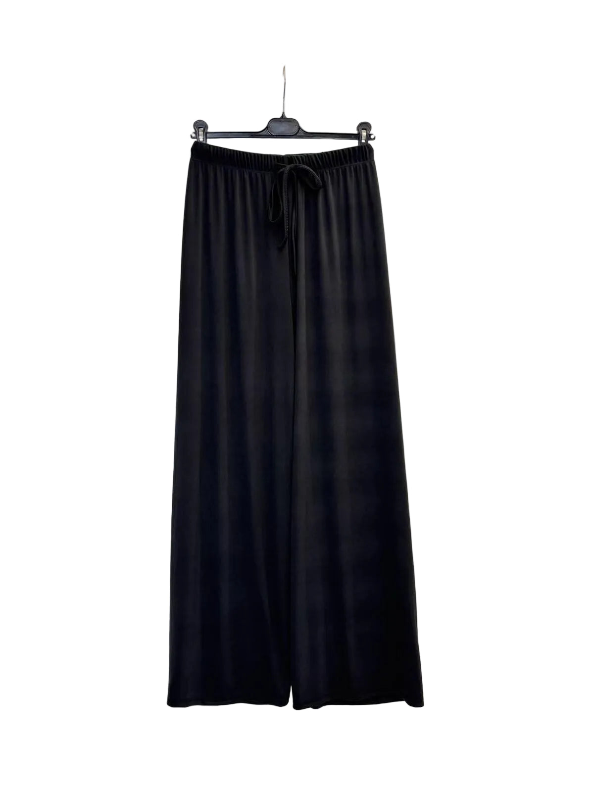 Black wide-leg lounge pants with an elastic drawstring waist, hanging on a black hanger against a plain white wall.